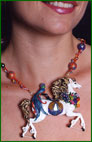 Model wearing sculpting horse necklace of polymer clay